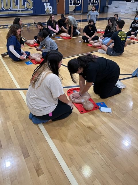 WBHS Medical Academy student demonstrating hands-only CPR to their trainee.