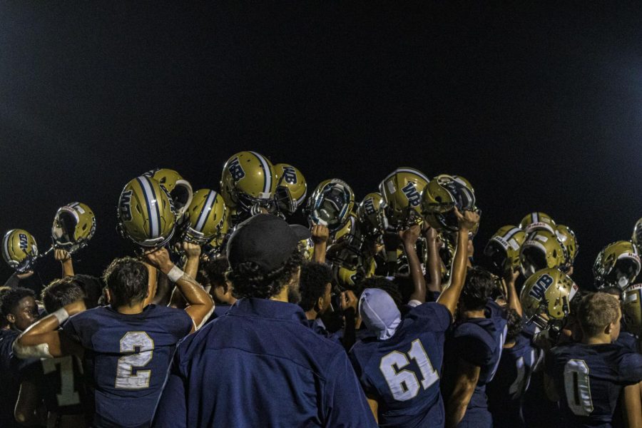 After the win, and out of excitement, West Boca puts their helmets up in the air.