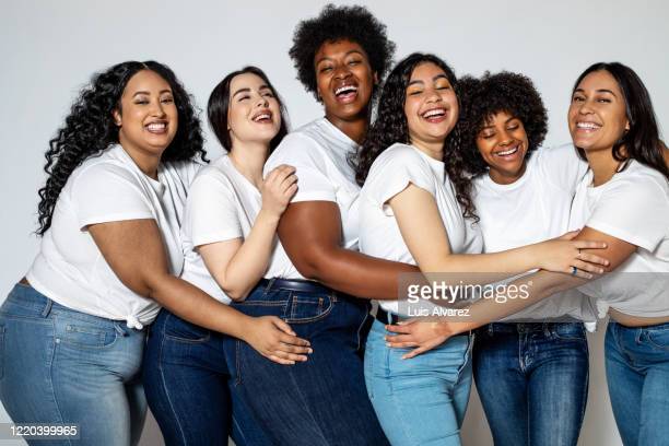 Women of all sizes  hugging each other promoting body positivity