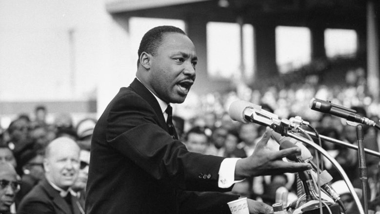Martin+Luther+King+Jr.+speaking+to+a+crowd+of+people.+