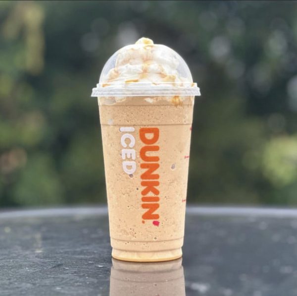  The Ice Spice Munchkin Drink infused with pumpkin doughnut holes and topped with whipped cream and caramel drizzle.