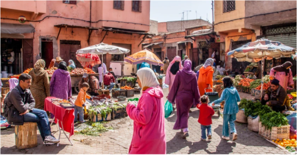 Woman strolls in bright and lively markets in Marrakech, Morocco