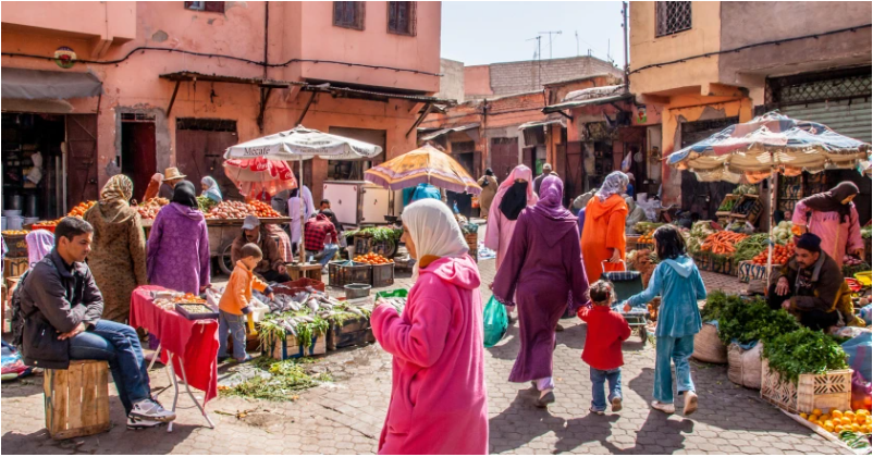 Woman+strolls+in+bright+and+lively+markets+in+Marrakech%2C+Morocco