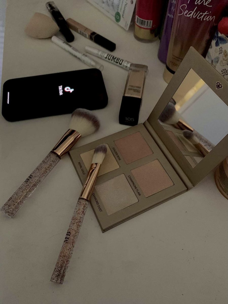 A photo of makeup spread out on a counter to reference the effects of Tiktok on teen girls. 