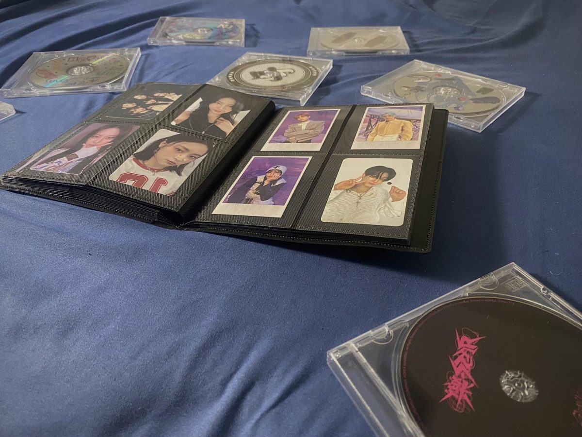 A photo that I took of my brothers K-pop album and photocard collection.