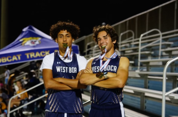 Dominic Caceres and Luke Rosenthal take 1st place in the 4x100 meter race at Palm Beach County Districts