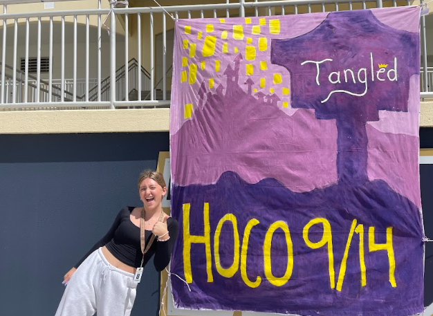 Posing with the Tangled homecoming flyer