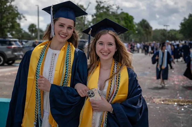 Salutatorian Alexa Mushlin and Addison Doherty entering the South Florida Fairground to Graduate