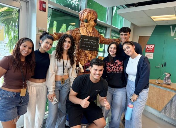 West Boca students at the Waste Management Facility entrance along side a "trash monster" statue