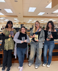 A picture of four high school students that had their own book published and advertising them in the West Boca media center